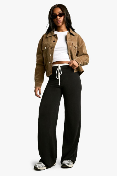 Персикова трикотажка, що викрила штани для ніг