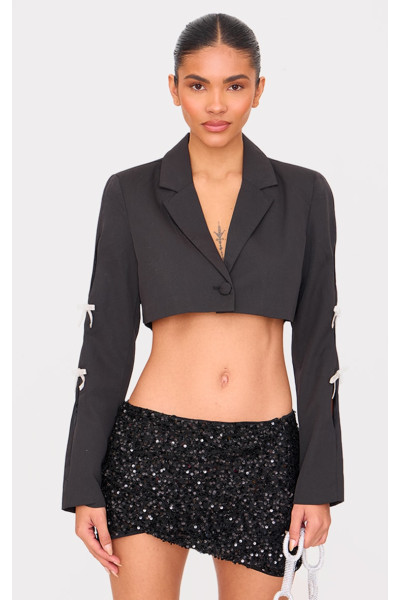 Чорний укорочений піджак із бантом зі стразами